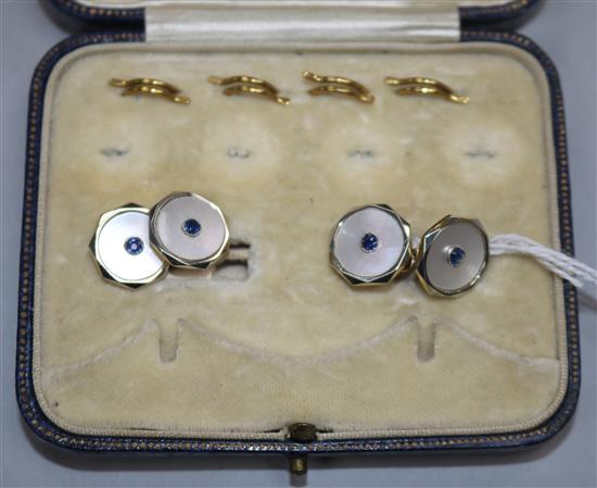 A pair of 18ct and 9ct gold, mother of pearl and gem set cufflinks.